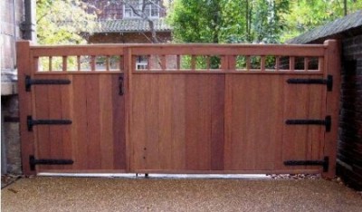 Wide wooden driveway gate and attached pedestrian gate